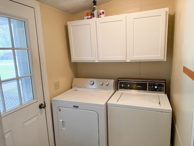 washroom featuring cabinet space and washer and dryer
