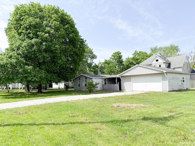 view of front of property with an attached garage and a front lawn