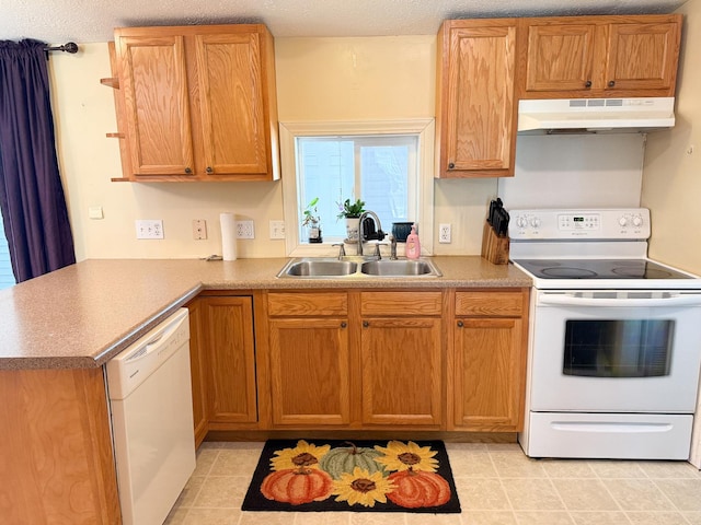 kitchen featuring under cabinet range hood, white appliances, a sink, and light countertops