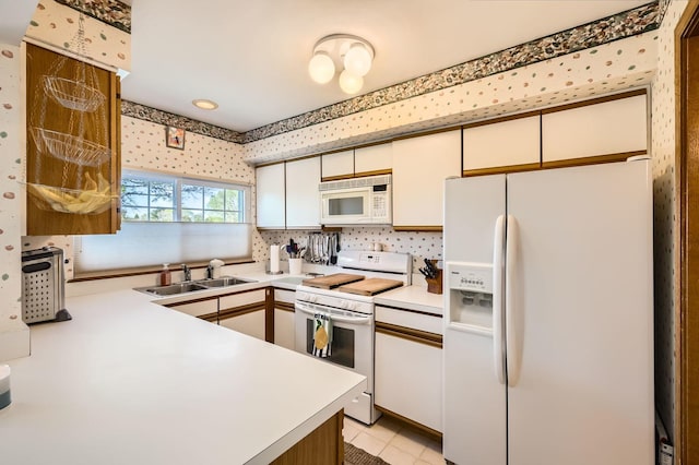 1650 Pebble Beach Cir, Elgin, IL 60123 - kitchen with white appliances, a sink, light countertops, white cabinets, and wallpapered walls
