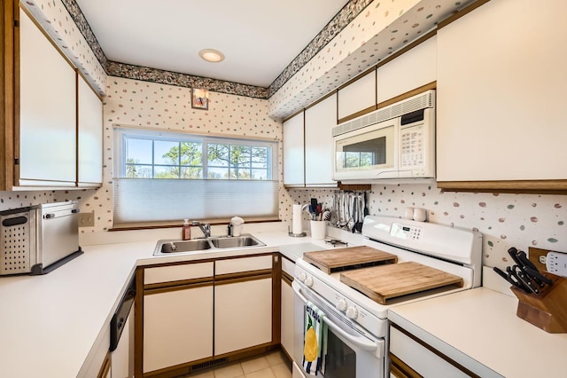 1650 Pebble Beach Cir, Elgin, IL 60123 - kitchen featuring white appliances, light countertops, a sink, and wallpapered walls