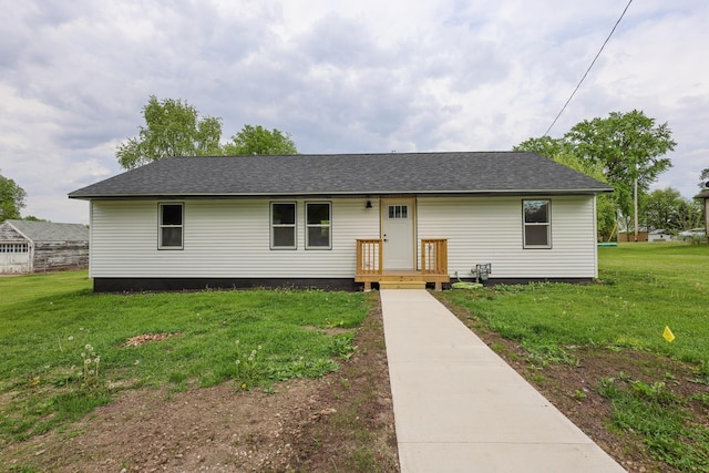 211 N Center St, Buda, IL 61314 - view of front facade featuring a front lawn and roof with shingles