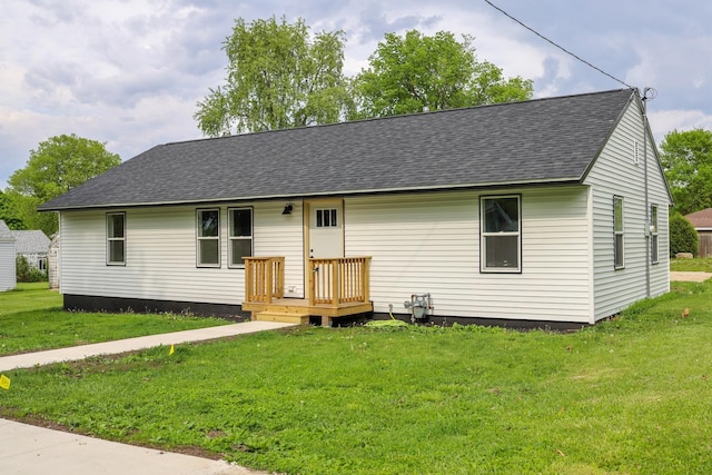 211 N Center St, Buda, IL 61314 - view of front facade featuring a shingled roof and a front lawn