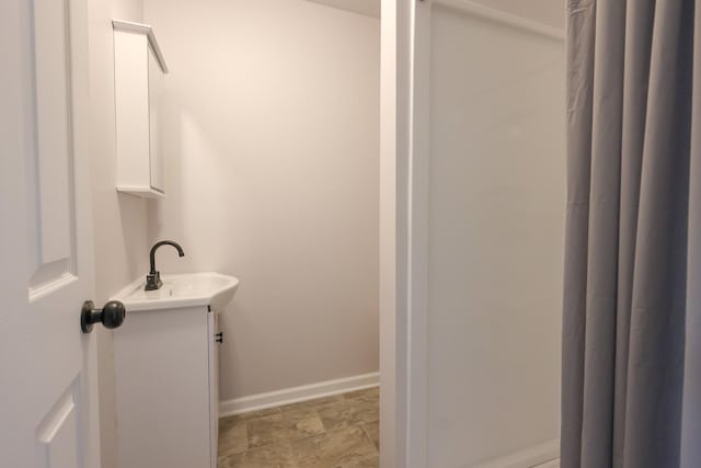 211 N Center St, Buda, IL 61314 - full bath with baseboards, vanity, and a shower with curtain