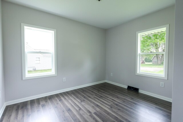 211 N Center St, Buda, IL 61314 - spare room featuring baseboards and dark wood-style flooring