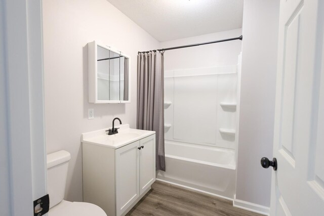 211 N Center St, Buda, IL 61314 - bathroom featuring wood finished floors, toilet, vanity, and shower / bath combo