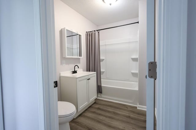 211 N Center St, Buda, IL 61314 - bathroom featuring wood finished floors, vanity, toilet, and shower / tub combo with curtain
