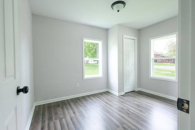 211 N Center St, Buda, IL 61314 - unfurnished bedroom with wood finished floors, baseboards, and a closet