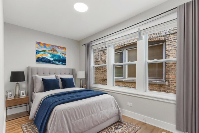 bedroom featuring wood finished floors and baseboards