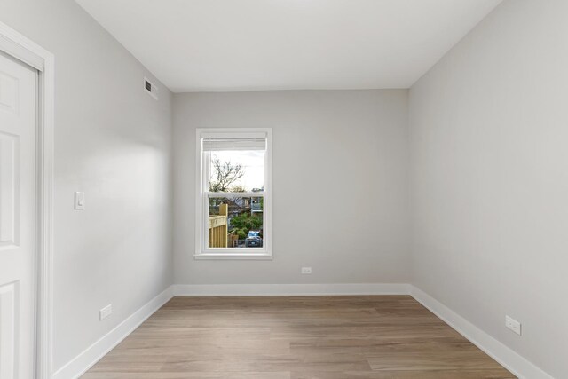 empty room featuring light wood-style flooring and baseboards