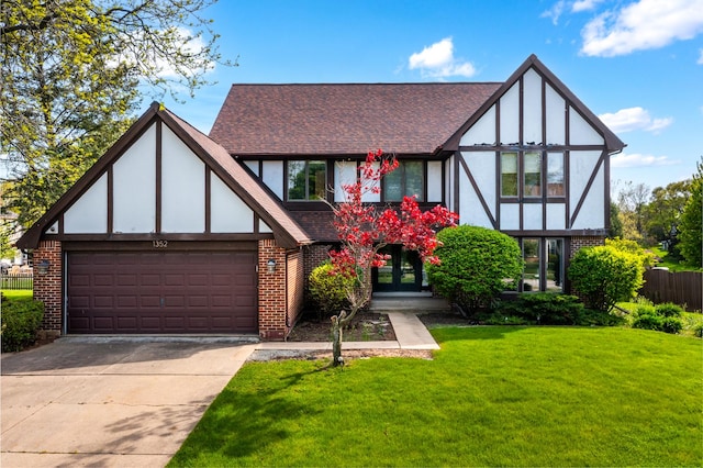 1352 Goldenrod Dr, Naperville, IL 60540 - tudor home featuring brick siding, french doors, a shingled roof, and driveway