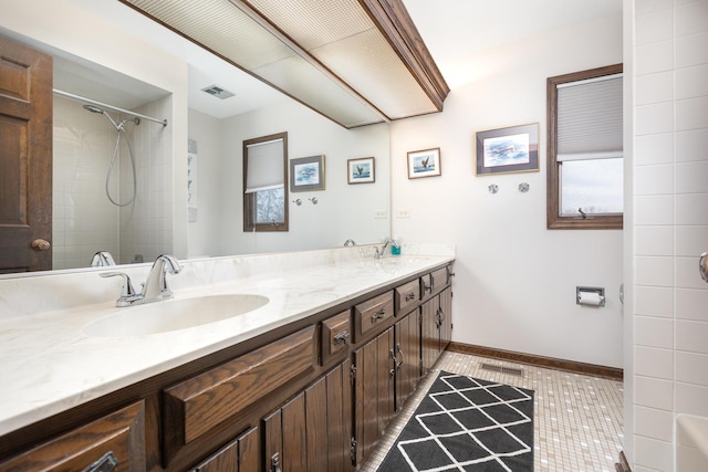 1352 Goldenrod Dr, Naperville, IL 60540 - bathroom featuring double vanity, baseboards, tile patterned floors, and a shower