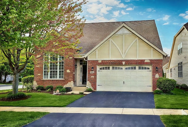 1265 Everwood Ln, Aurora, IL 60505 - english style home with asphalt driveway, brick siding, and a front yard