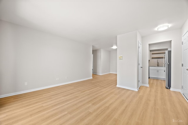 17963 Huntleigh Ct Unit 302, Country Club Hills, IL 60478 - unfurnished living room with light wood-type flooring, baseboards, and a sink
