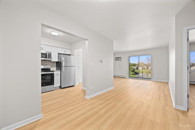 17963 Huntleigh Ct Unit 302, Country Club Hills, IL 60478 - kitchen with appliances with stainless steel finishes, a baseboard heating unit, white cabinets, light wood-type flooring, and open floor plan