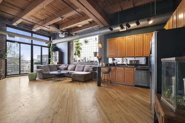 2735 W Armitage Ave Unit 309, Chicago, IL 60647 - living room featuring beamed ceiling, light wood-style floors, brick wall, and wood ceiling