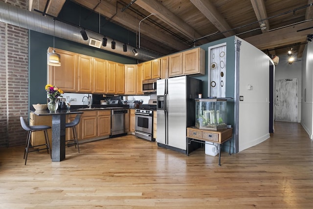 2735 W Armitage Ave Unit 309, Chicago, IL 60647 - kitchen with dark countertops, stainless steel appliances, light wood-style flooring, and visible vents