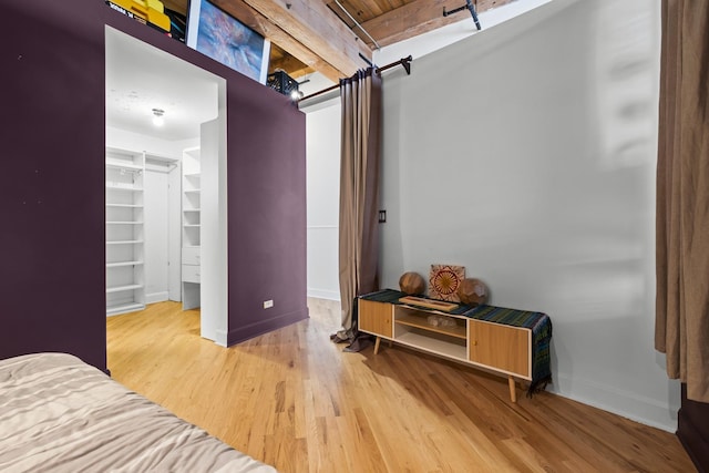 2735 W Armitage Ave Unit 309, Chicago, IL 60647 - bedroom featuring a spacious closet, baseboards, and wood finished floors