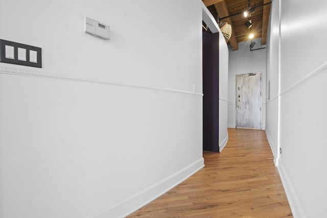 2735 W Armitage Ave Unit 309, Chicago, IL 60647 - hall featuring baseboards, beam ceiling, rail lighting, and light wood-type flooring