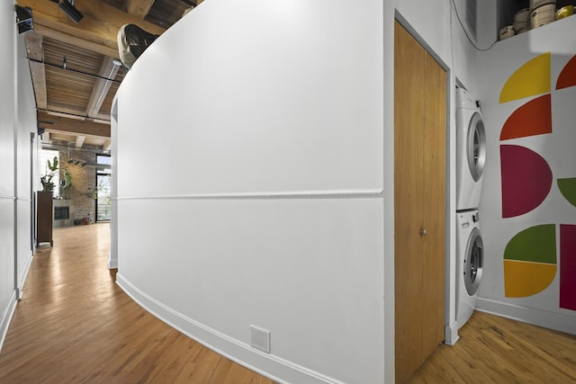 2735 W Armitage Ave Unit 309, Chicago, IL 60647 - corridor featuring baseboards, stacked washer and dryer, visible vents, and wood finished floors