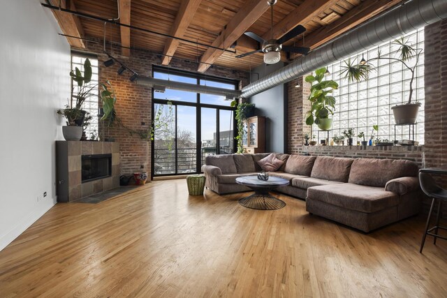 2735 W Armitage Ave Unit 309, Chicago, IL 60647 - living area featuring wooden ceiling, wood finished floors, a ceiling fan, and beam ceiling
