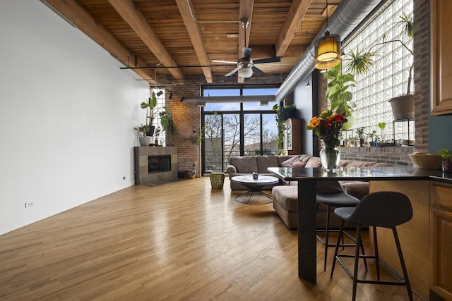 2735 W Armitage Ave Unit 309, Chicago, IL 60647 - living room featuring wood finished floors, wooden ceiling, a fireplace, beamed ceiling, and a ceiling fan