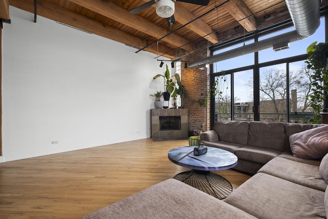2735 W Armitage Ave Unit 309, Chicago, IL 60647 - living area with wooden ceiling, ceiling fan, wood finished floors, beamed ceiling, and a fireplace