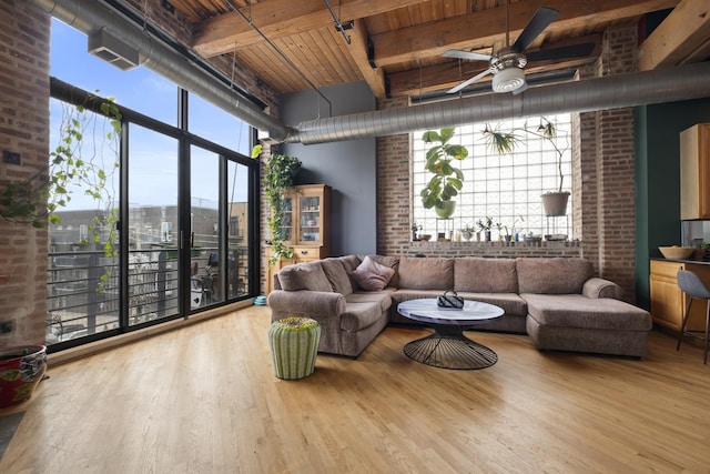 2735 W Armitage Ave Unit 309, Chicago, IL 60647 - living room with wood finished floors, beamed ceiling, a ceiling fan, brick wall, and wood ceiling