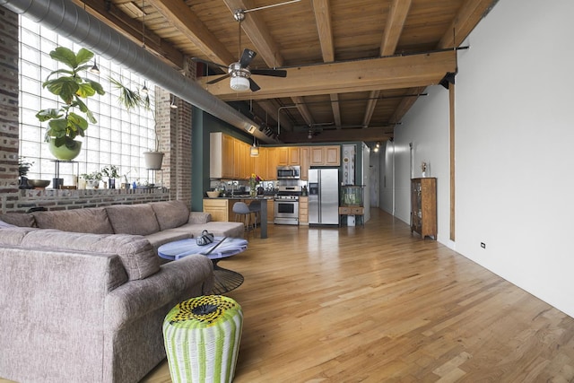 2735 W Armitage Ave Unit 309, Chicago, IL 60647 - living area featuring wood ceiling, beam ceiling, light wood-style flooring, and ceiling fan