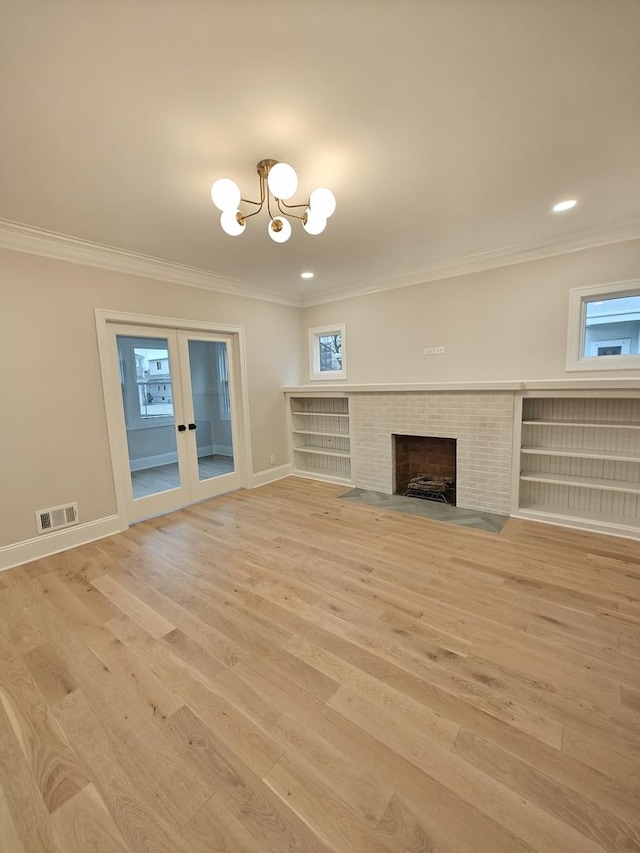 unfurnished living room featuring light wood-type flooring, visible vents, an inviting chandelier, and crown molding