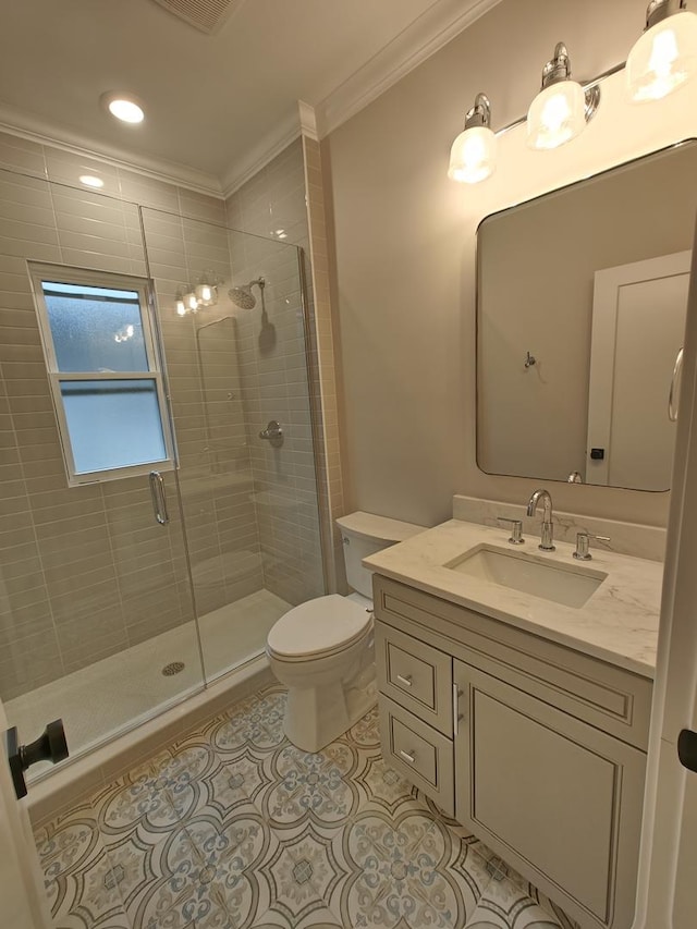 bathroom featuring toilet, tile patterned floors, crown molding, and a stall shower