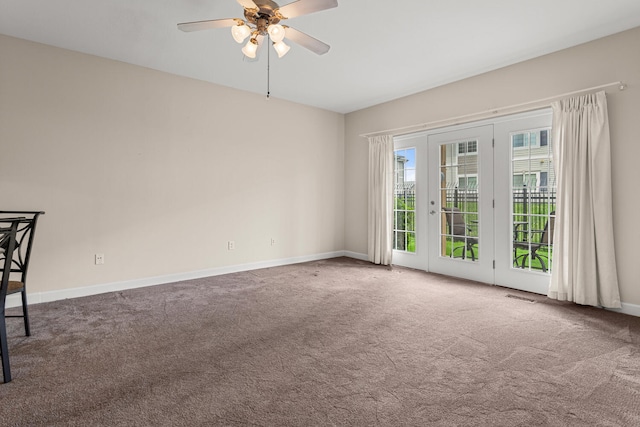 carpeted empty room featuring ceiling fan and baseboards
