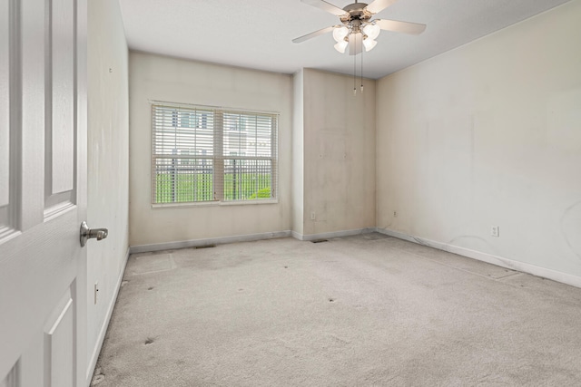 unfurnished room featuring carpet, ceiling fan, and baseboards