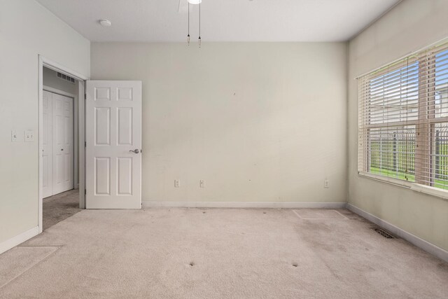 carpeted empty room featuring baseboards