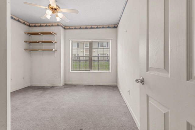 unfurnished room featuring carpet flooring, ceiling fan, and baseboards