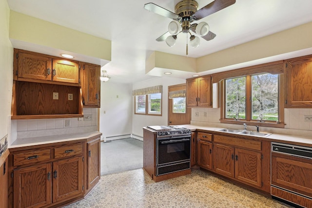 200 W Eisenhower St, Waterman, IL 60556 - kitchen with brown cabinets, black range with electric stovetop, paneled dishwasher, and a sink