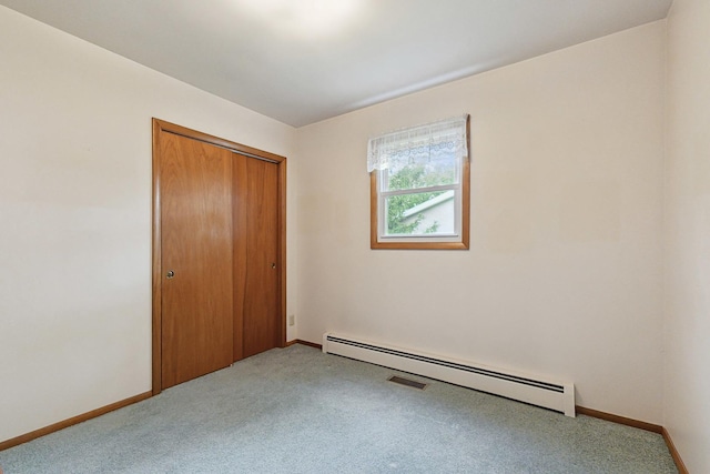 200 W Eisenhower St, Waterman, IL 60556 - unfurnished bedroom featuring baseboards, carpet flooring, baseboard heating, and a closet