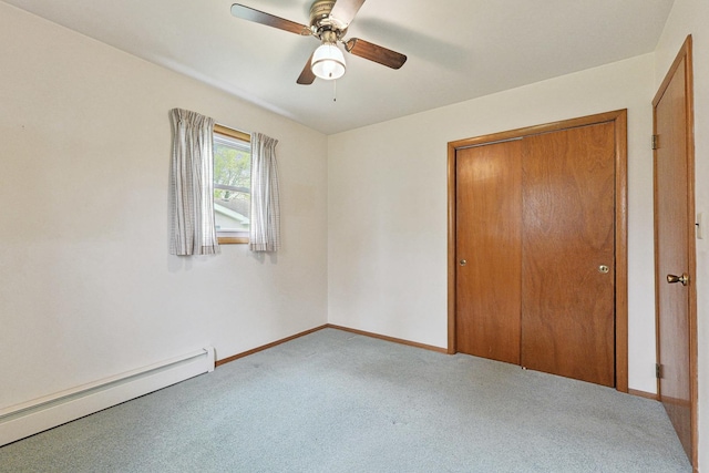 200 W Eisenhower St, Waterman, IL 60556 - unfurnished bedroom with carpet, a closet, baseboards, ceiling fan, and a baseboard radiator