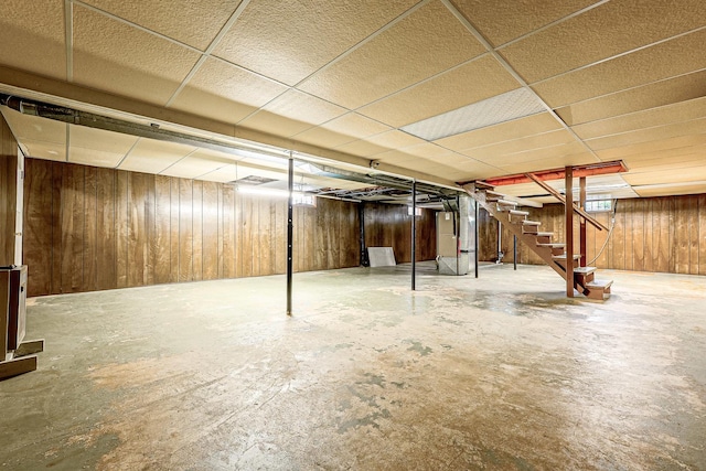 200 W Eisenhower St, Waterman, IL 60556 - below grade area with stairway, wood walls, and a paneled ceiling