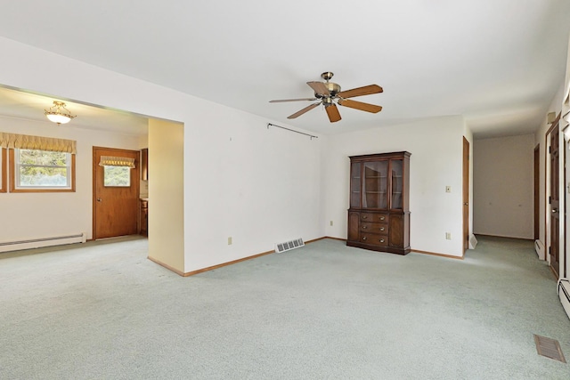 200 W Eisenhower St, Waterman, IL 60556 - unfurnished room featuring light colored carpet, visible vents, a ceiling fan, baseboard heating, and baseboards
