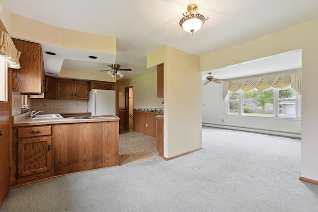 200 W Eisenhower St, Waterman, IL 60556 - kitchen with freestanding refrigerator, baseboard heating, a ceiling fan, and a sink