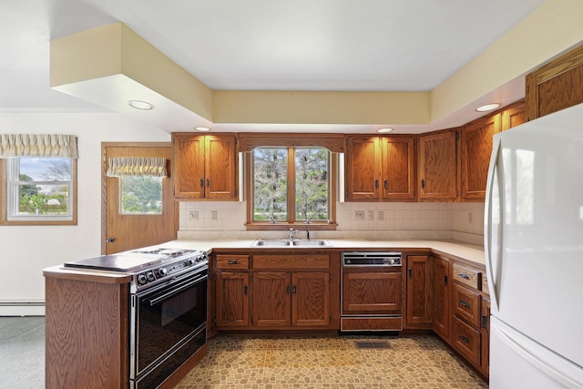 200 W Eisenhower St, Waterman, IL 60556 - kitchen featuring freestanding refrigerator, black / electric stove, paneled dishwasher, a sink, and a peninsula
