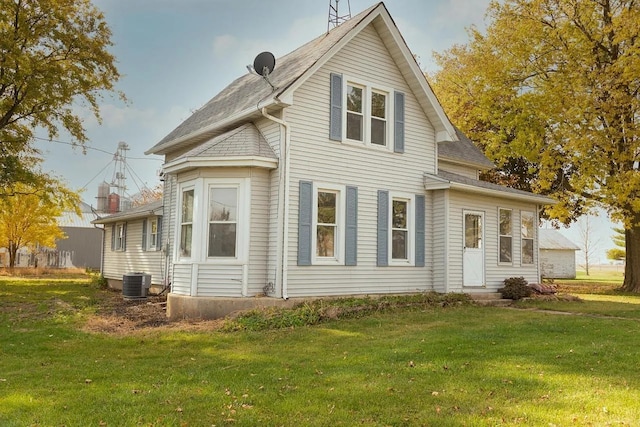 642 Angling Rd, Paw Paw, IL 61353 - rear view of property featuring a yard, roof with shingles, and central AC