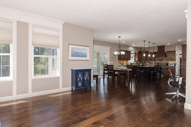 9760 Janel Dr, Bloomington, IL 61705 - living room with dark wood-style floors, plenty of natural light, recessed lighting, and a chandelier