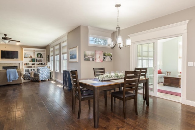 9760 Janel Dr, Bloomington, IL 61705 - dining area with a chandelier, dark wood-style flooring, a ceiling fan, and healthy amount of natural light