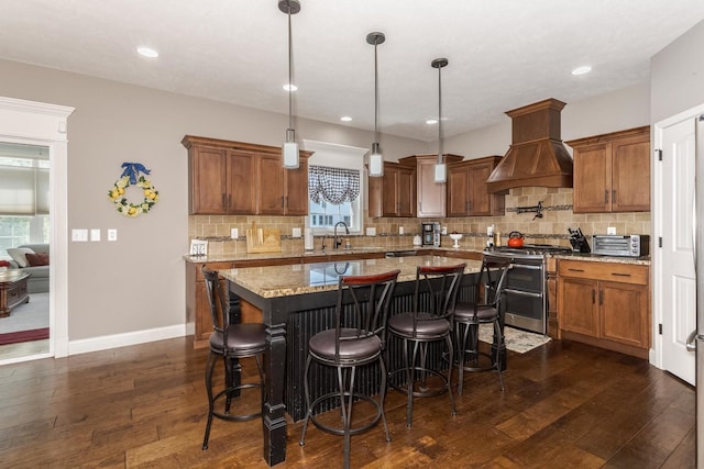 9760 Janel Dr, Bloomington, IL 61705 - kitchen with double oven range, custom range hood, dark wood-style flooring, a center island, and tasteful backsplash