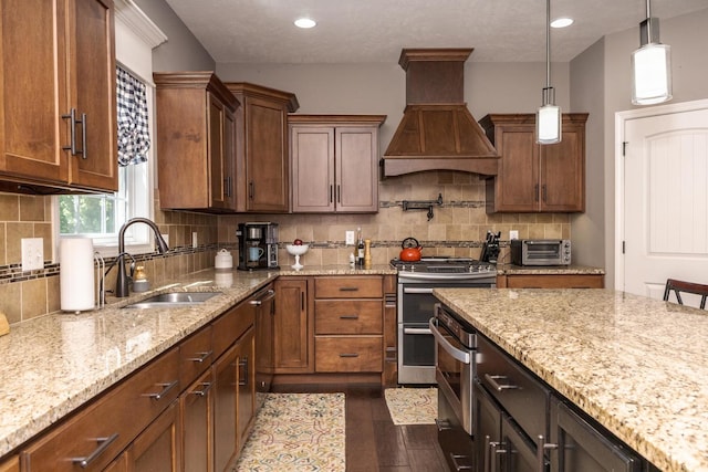 9760 Janel Dr, Bloomington, IL 61705 - kitchen featuring a sink, custom range hood, double oven range, dark wood finished floors, and light stone counters