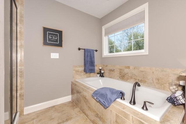9760 Janel Dr, Bloomington, IL 61705 - full bathroom with baseboards, a garden tub, tile patterned flooring, and a shower with door
