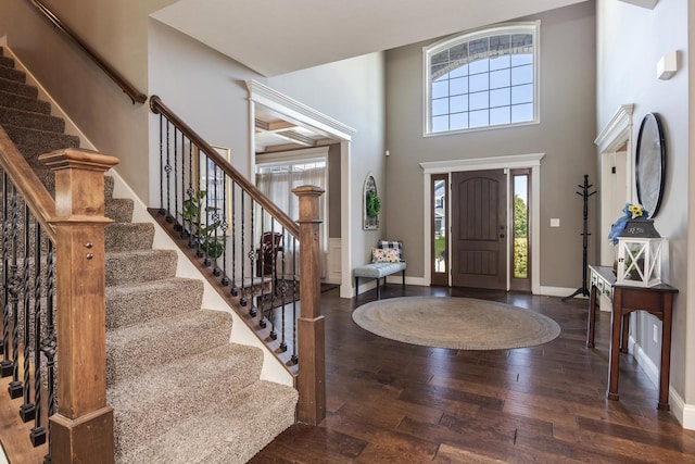 9760 Janel Dr, Bloomington, IL 61705 - foyer entrance featuring wood-type flooring, stairs, baseboards, and a towering ceiling