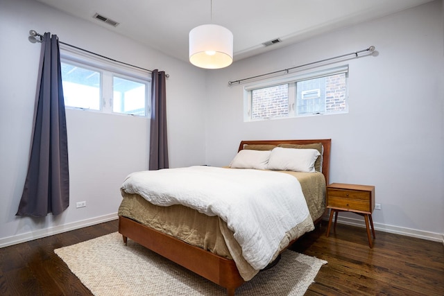 bedroom featuring baseboards and wood finished floors